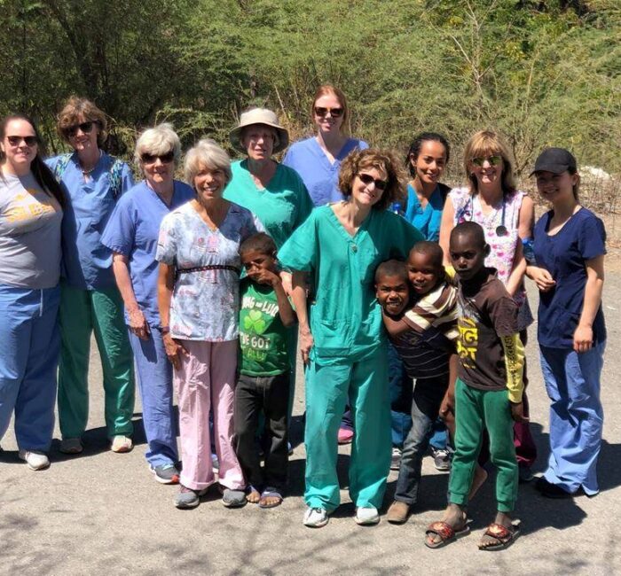 Medical Volunteers With Local Children In Dominican